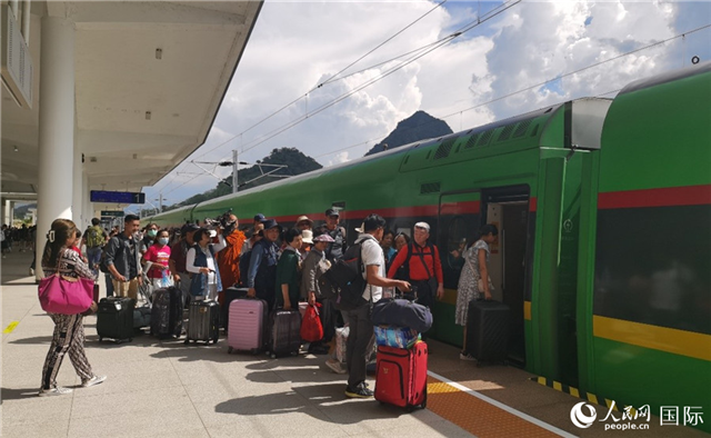 乘坐中老鐵路國(guó)際旅客列車的旅客在老撾瑯勃拉邦站排隊(duì)上車。人民網(wǎng)記者 杜明明攝