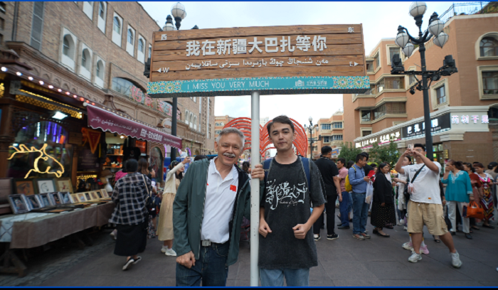 潘維廉和維吾爾族青年伊木蘭“打卡”大巴扎。主辦方供圖