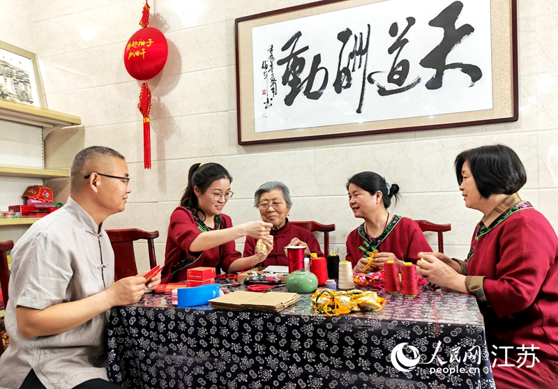 王秀英老人指導(dǎo)孫女制作香包。人民網(wǎng) 閆峰攝