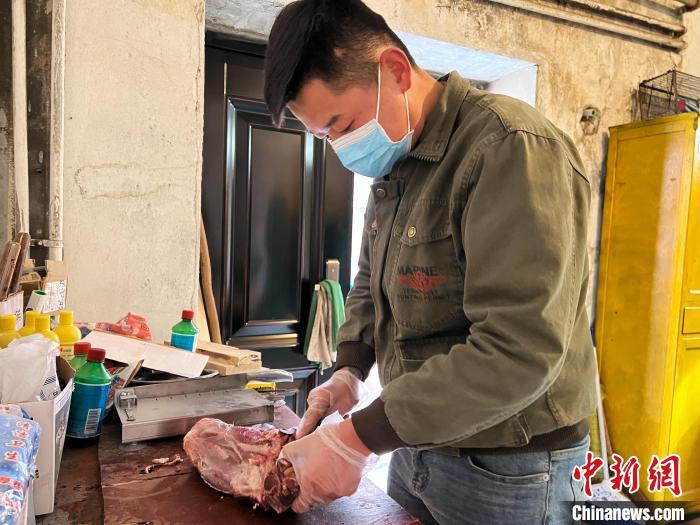圖為雪豹“奶爸”史壽軍正在準(zhǔn)備投喂雪豹的食材?！●R銘言 攝