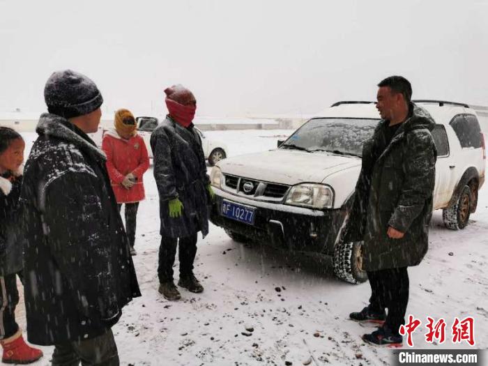 圖為扎西鬧吾(右一)與當(dāng)?shù)啬翍艚徽劇｀]儲銀行青海省分行供圖